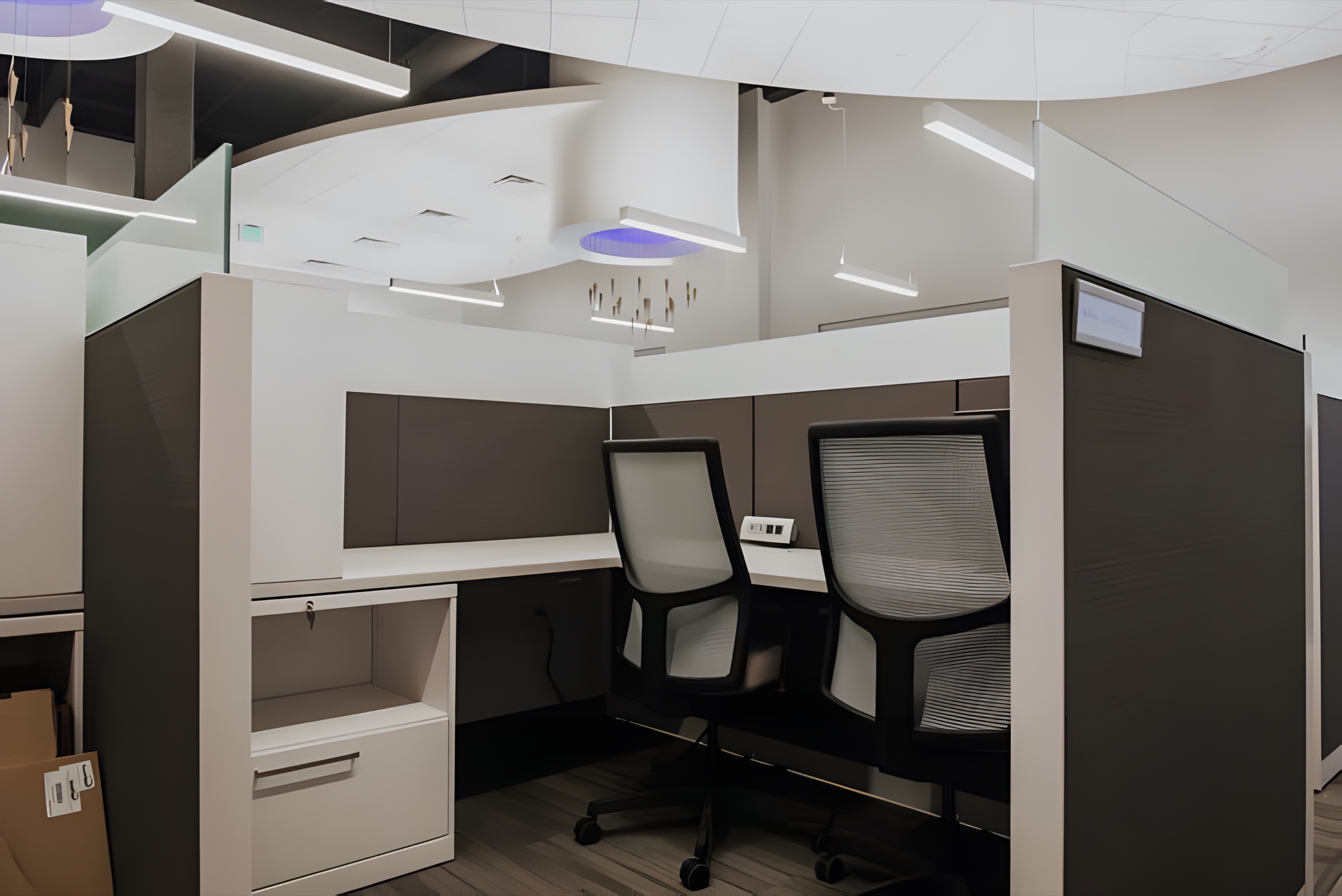 An office workstation under recessed and pendant lighting