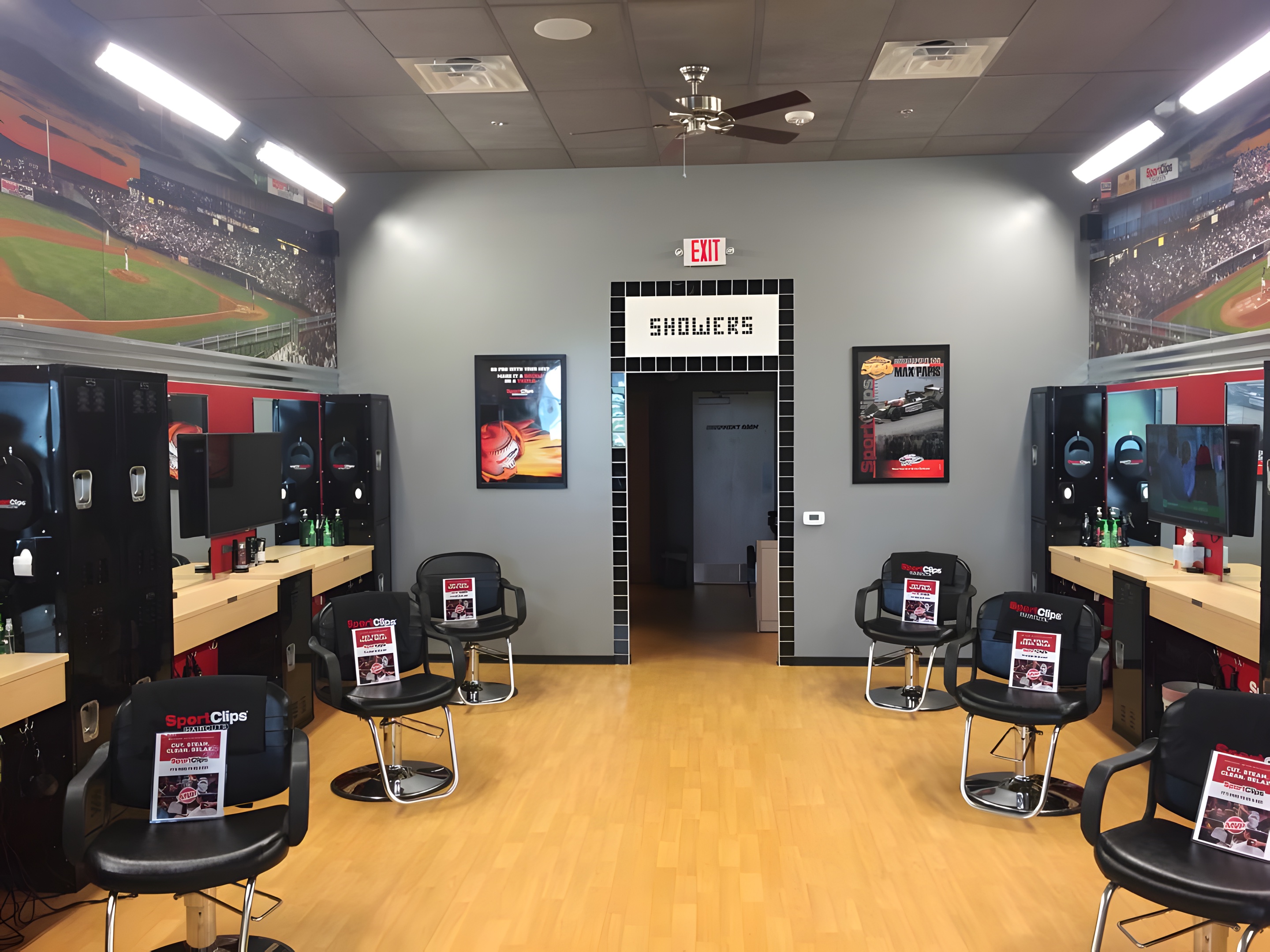 A barbershop with stations along a mural wall