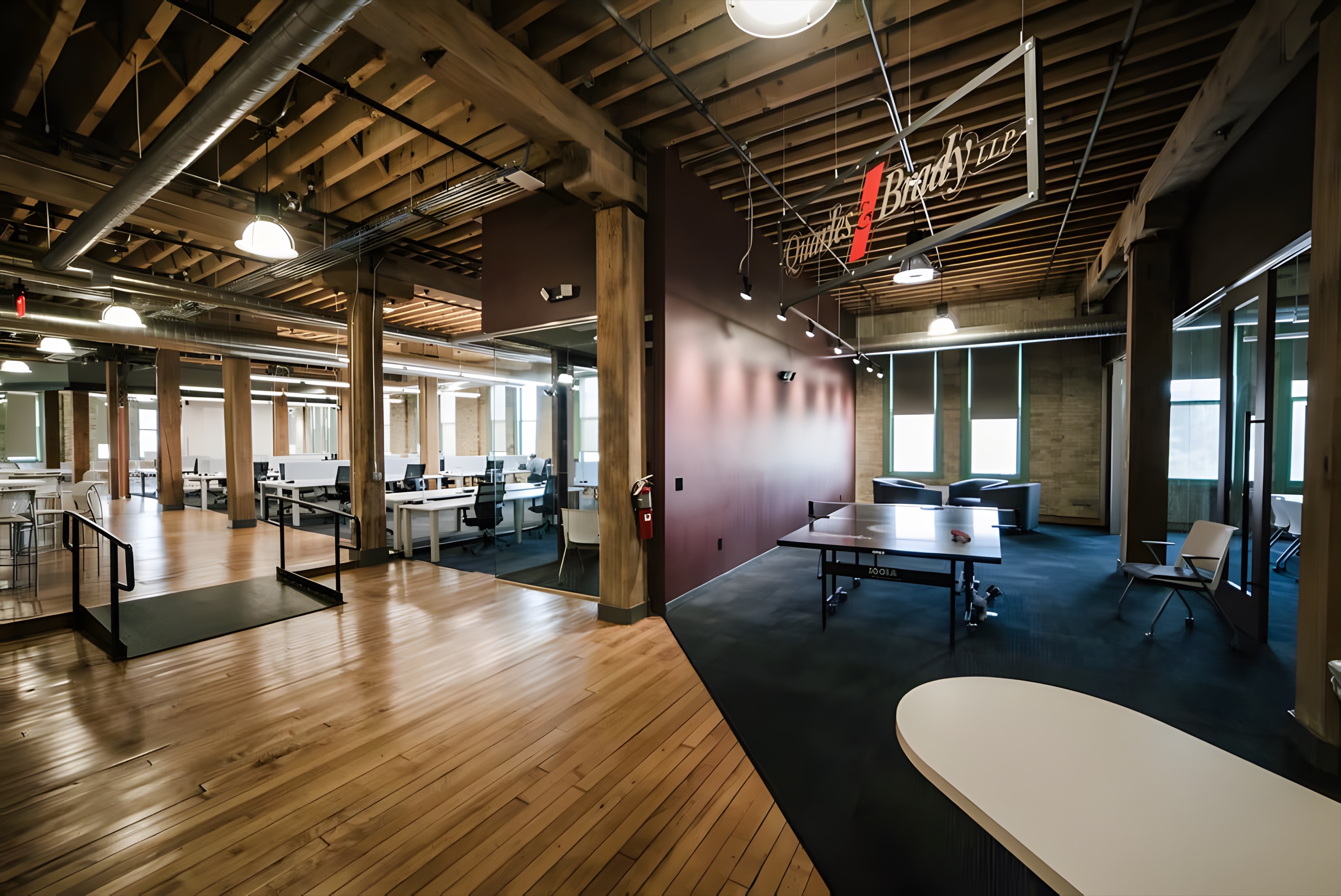 A loft office with exposed timber ceilings and new lighting